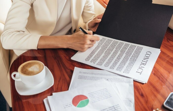 A woman writing a legal binding contract